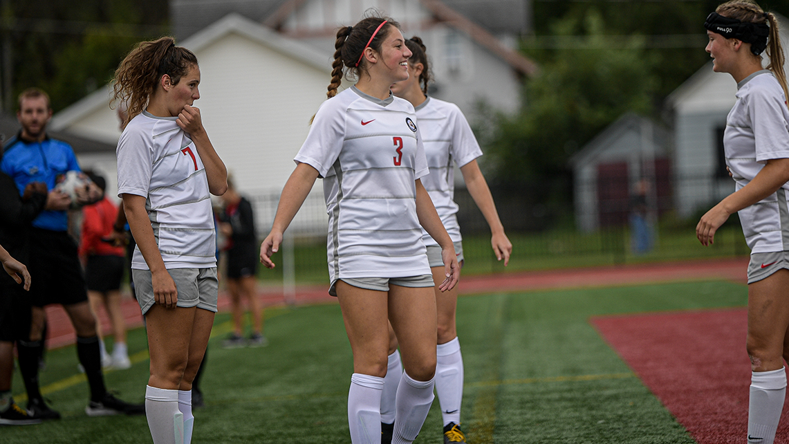 Sophomore Julia Wagoner (7), freshmen Maddie Hays (3) and Liz Naasz (R) [Photo by Vicki Born]